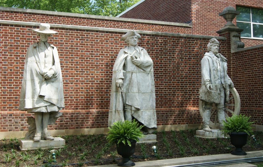 Statues of Davie, Caldwell, and Whitman standing to the right of the Historical Society building