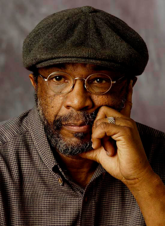 Headshot of artist Moe Brooker
