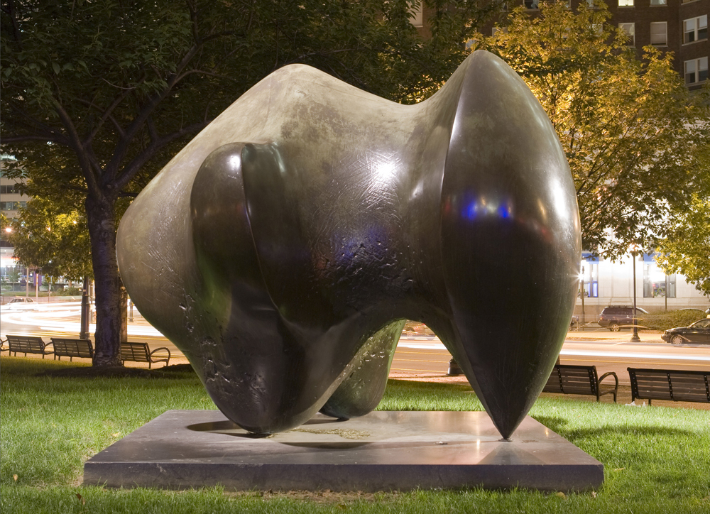 Three Way Piece abstract bronze sculpture on the Parkway illuminated at night